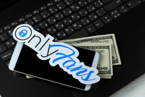 Onlyfans paper logo with smartphone and dollar bills