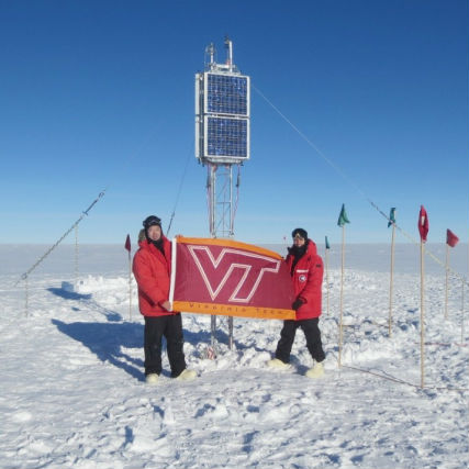Zhonghua Xu (left) and Mike Hartinger represent Virginia Tech in front of solar panels at their base camp in Antarctica.