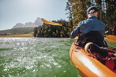 senior man canoeing in a lake