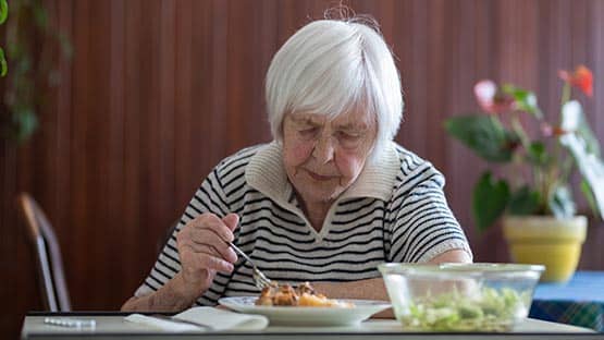 senior elderly eating alone lunch