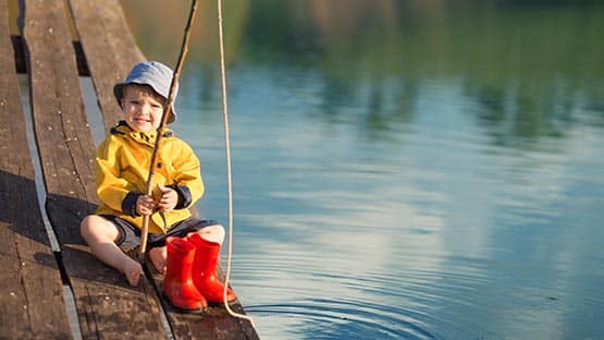 child fishing at lake