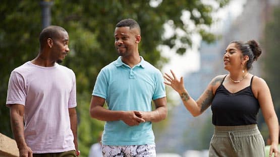 Three friends talking outside