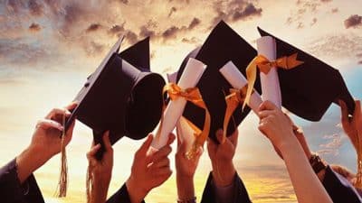 graduation caps in air