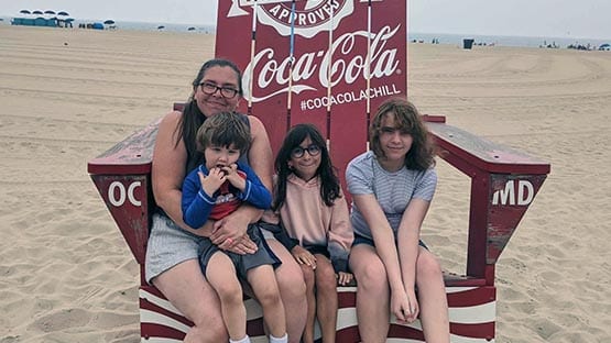 mother with three children at beach