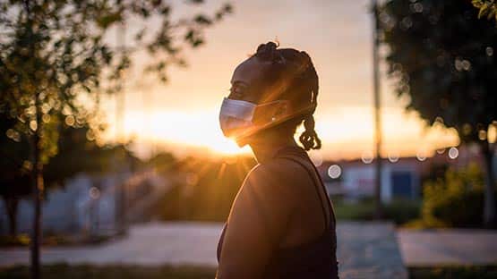 person in mask outdoors