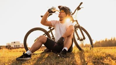 cyclist stopped to drink water