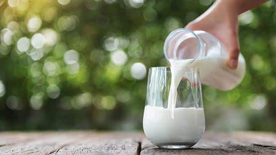 pouring a glass of milk