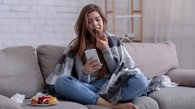 teenager eating on couch