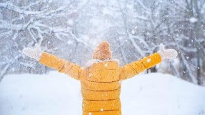 woman outside embracing snow