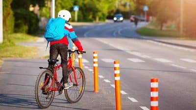 child on bike near crosswalk