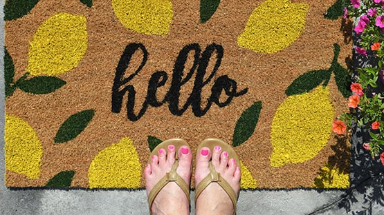 hello door mat with flip flops feet flowers summer