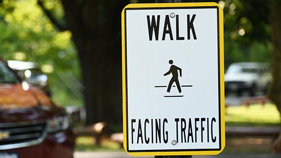 pedestrian sign walk facing traffic accident car