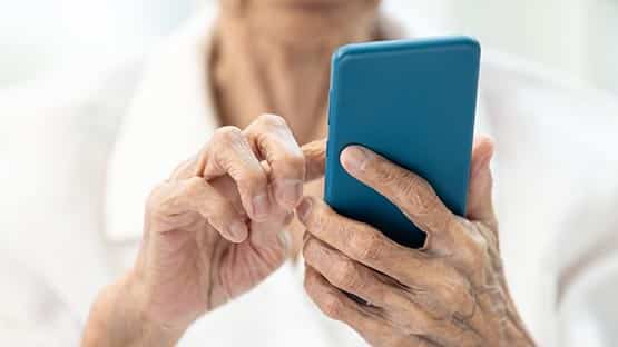senior woman on cell phone fraud scam