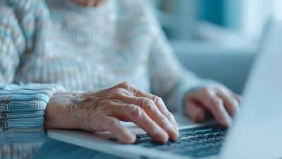 senior woman on computer laptop elder fraud scam