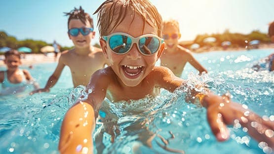 children beach pool summer sunscreen