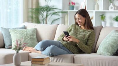 digital home couch woman smartphone phone