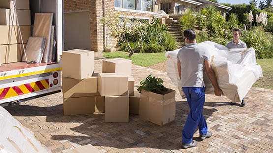 A moving truck being loaded outside a suburban home before a long-distance move