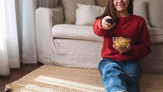 woman TV watching snack entertainment remote
